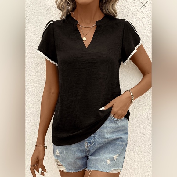 This blouse is a black patchwork short sleeve V neck blouse. - Picture 4 of 5